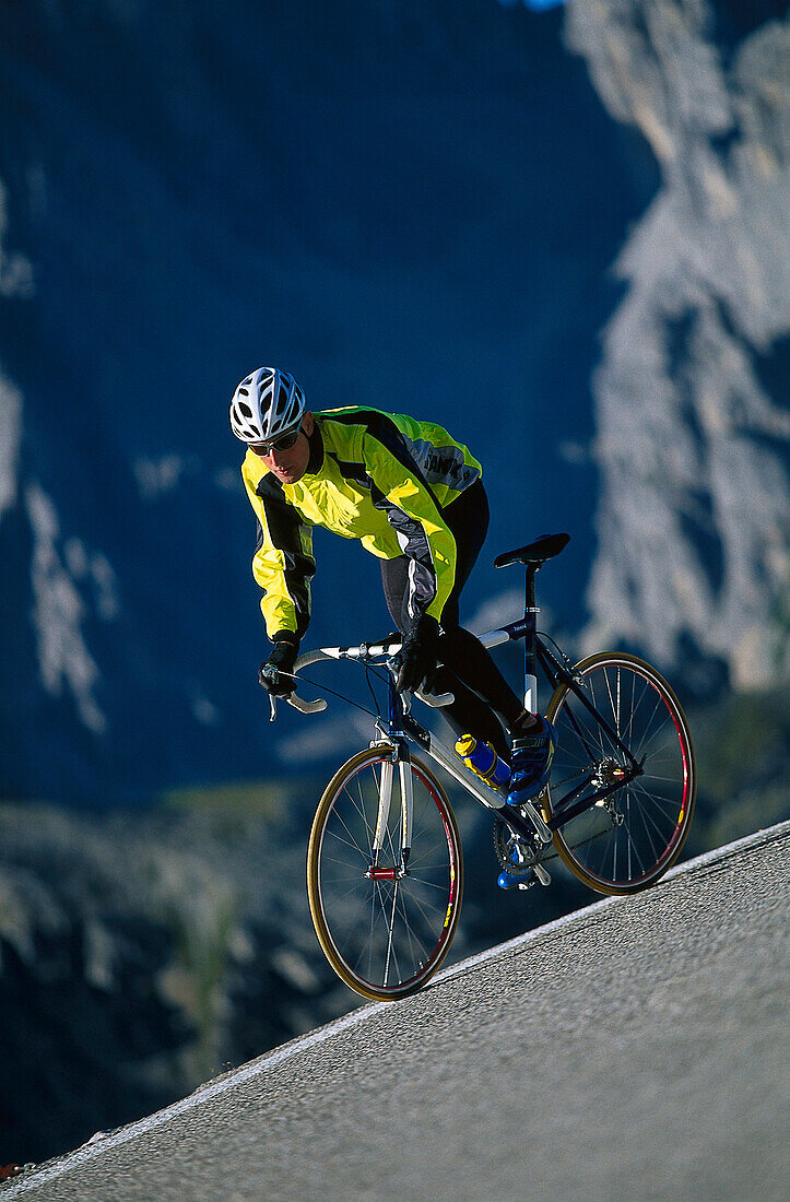 Racing-cyclist on a downhill stretch, Cortina d' Ampezzo, Dolomites, Italy