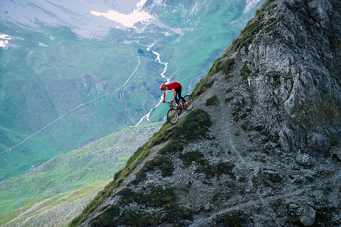 Ein Mann mit Mountainbike beim Freeriding, Arosa, Graubünden, Schweiz, Europa
