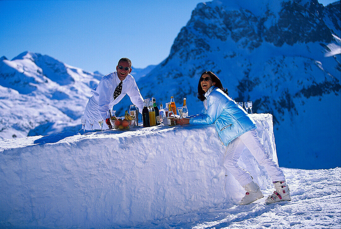 People at a bar made of snow under blue sky, Palmenalpe, Lech, Vorarlberg, Austria, Europe