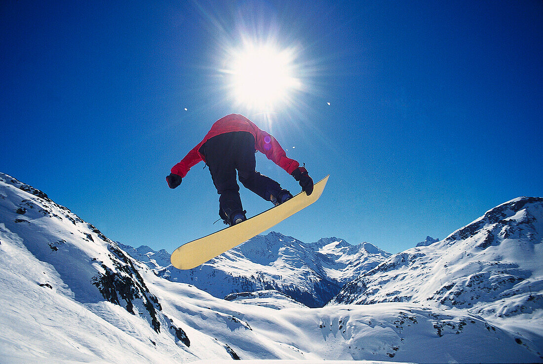 Snowboarder jumping, Arlberg, Vorarlberg, Austria