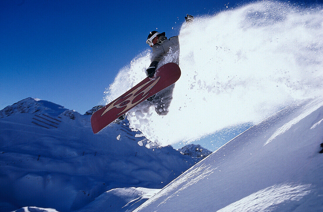 Snowboarder jumping, Arlberg, Vorarlberg, Austria