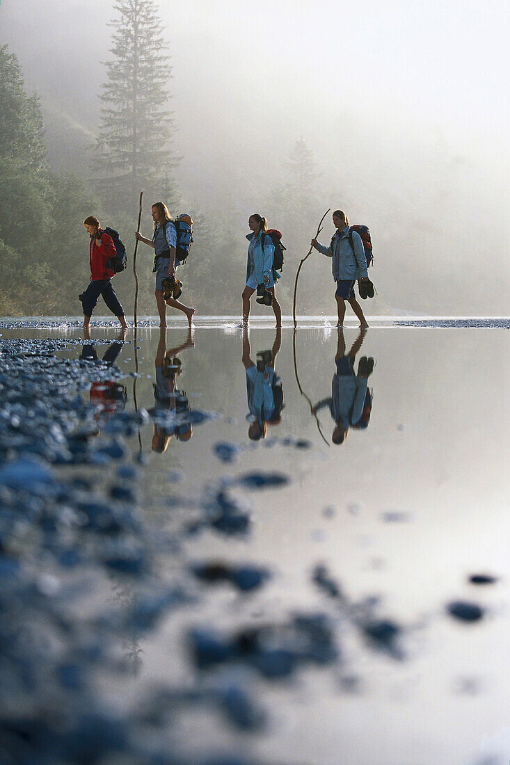 Hikers crossing a river