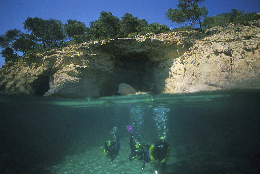 Divers off rocky coast, Cap de Formentor, Majorca, Balearic Islands, Spain, Europe