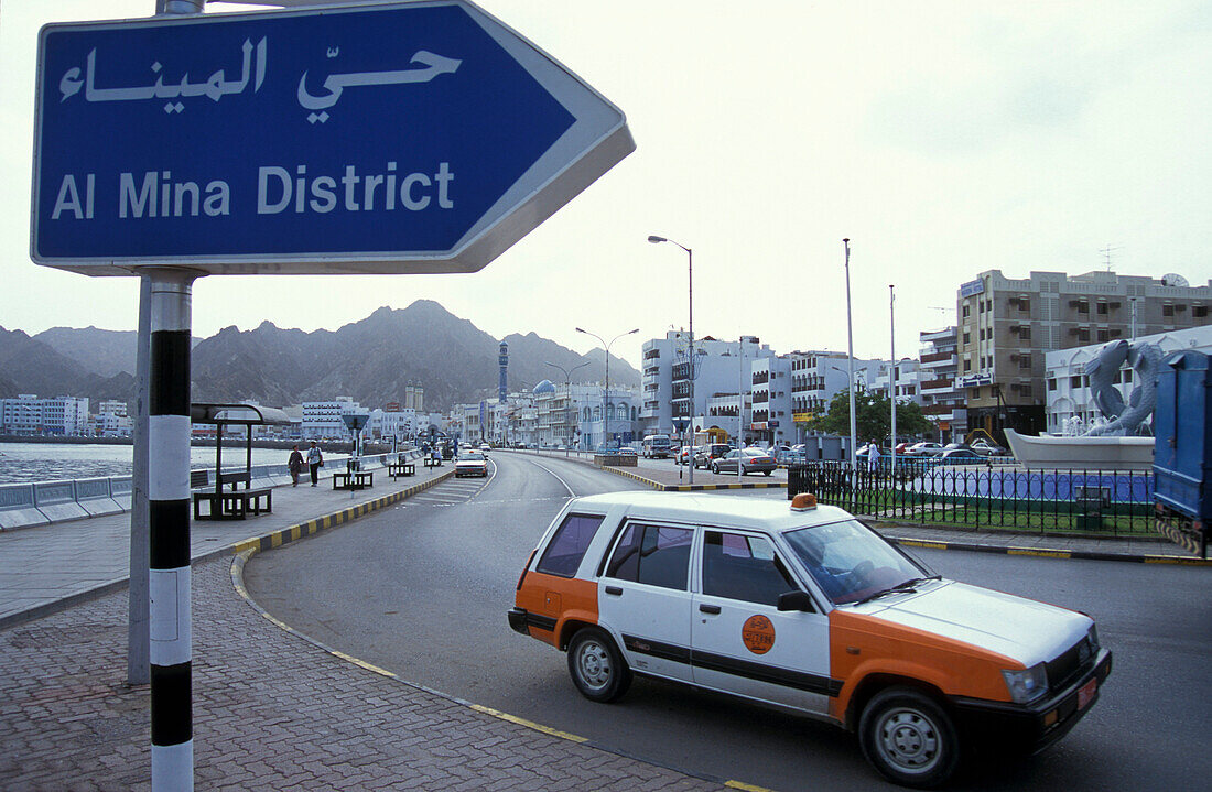 Street sign and taxi in front of the houses of Muscat, Oman, Middle East, Asia