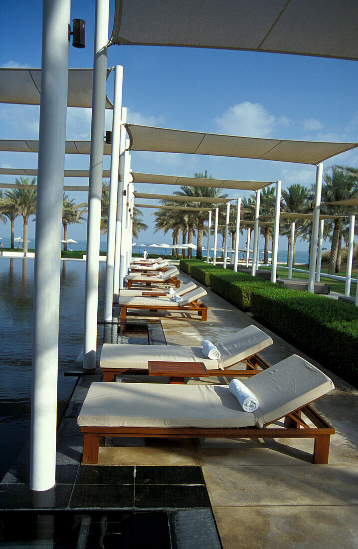 Sonnenliegen und Palmen am Serai Pool, The Chedi Hotel, Maskat, Oman, Vorderasien, Asien