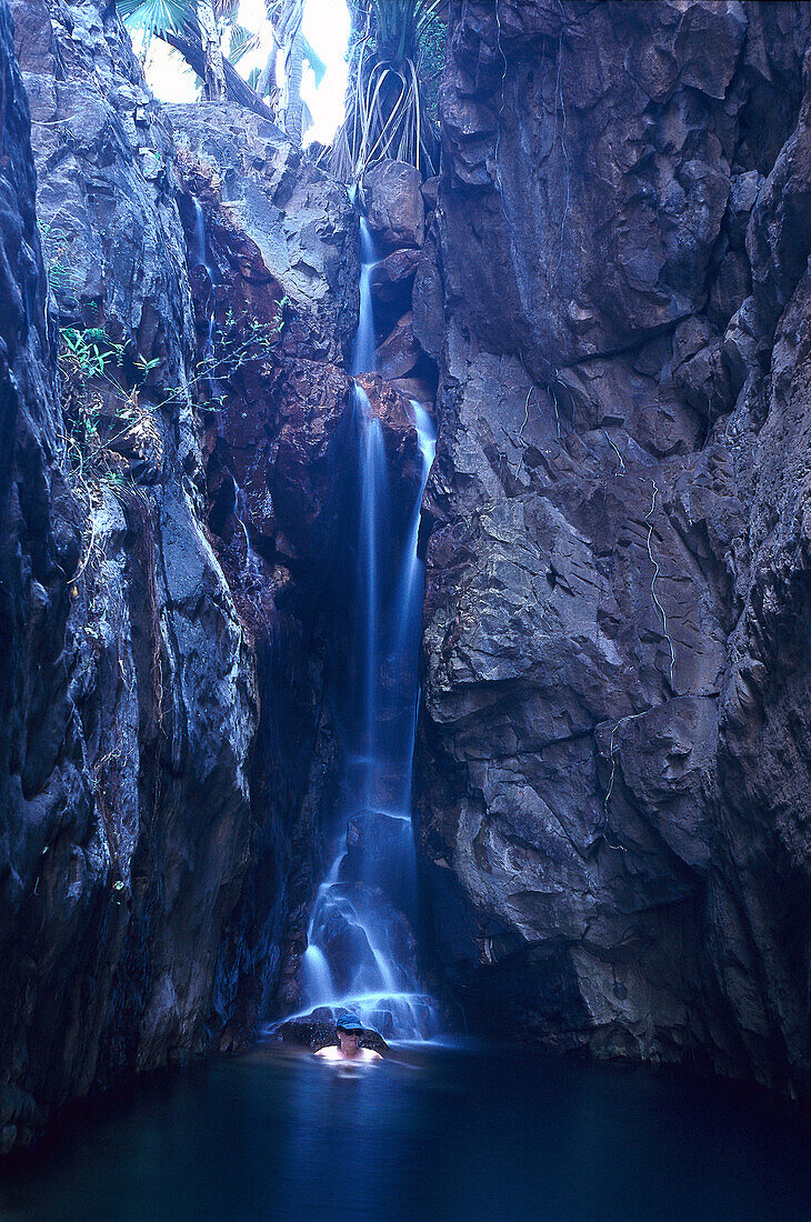 A person bathing in Mac Micking Pool, El Questro Gorge, Kimberley Plateau, Australia