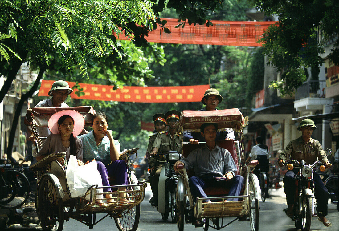 People on rickshaws in the streets of the old town, Hanoi, Vietnam, Asia