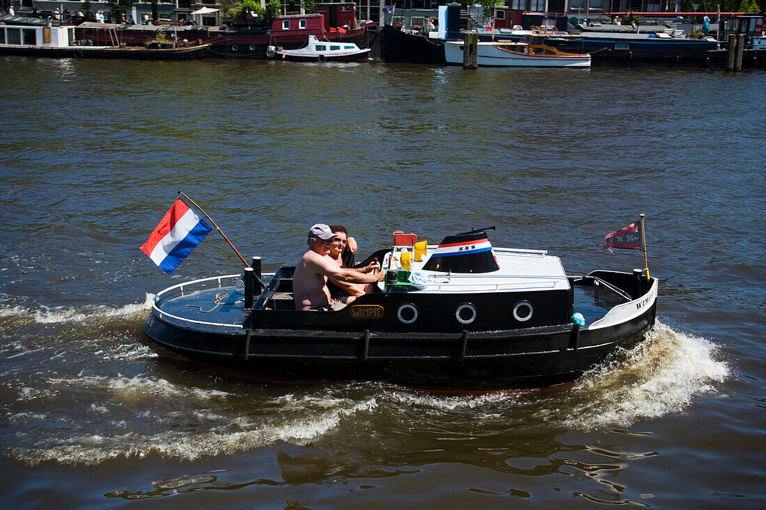 Leisure Boat, Magere Brug, Amstel, Couple in mini ocean liner on Amstel near of Magere Brug Skinny Bridge, , Amsterdam, Holland, Netherlands