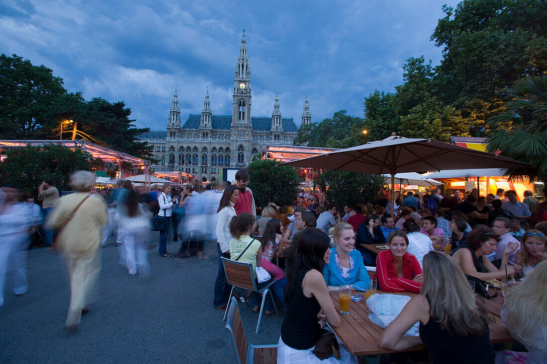 Guests in a pavement cafe near city hall in the evening, Vienna, Austria