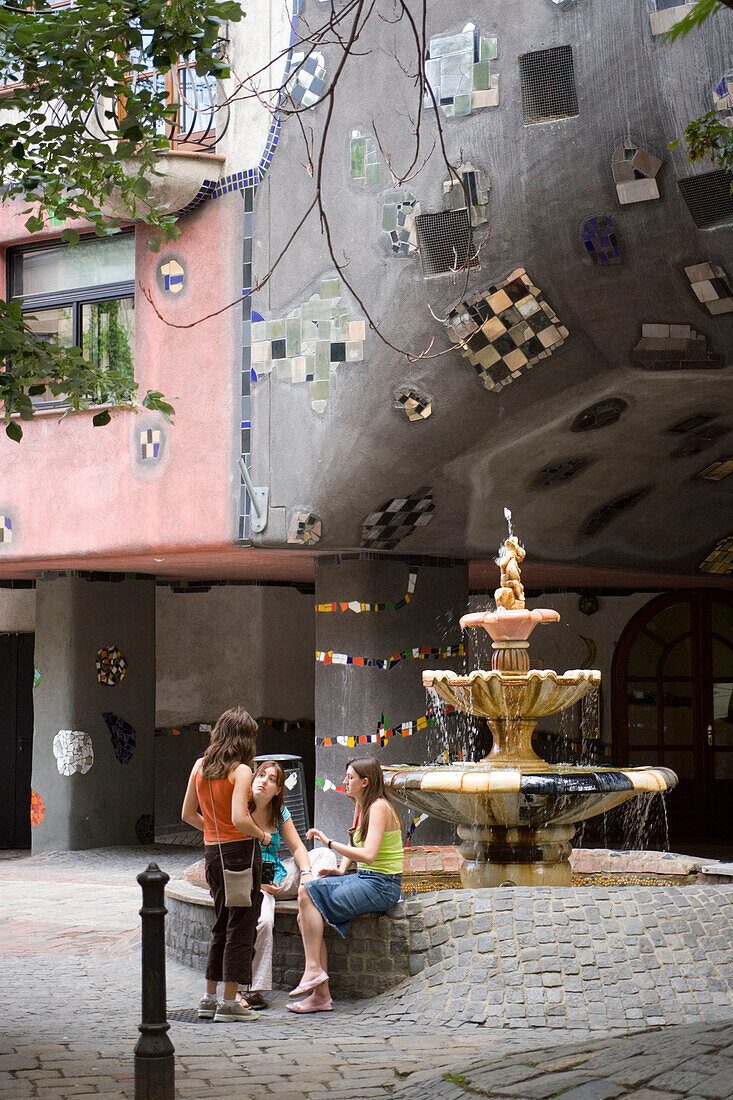 Girls in front of Hundertwasserhaus, Vienna, Austria