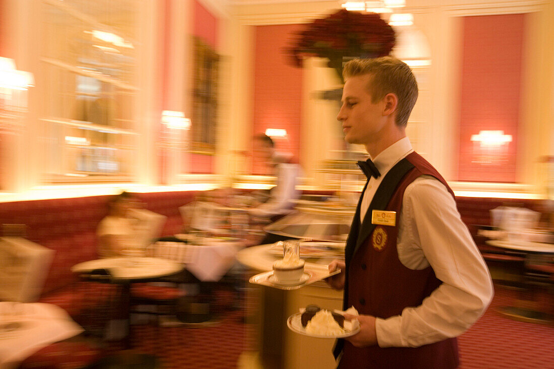 Waiter serving Sachertorte, Hotel Sacher, Vienna, Austria