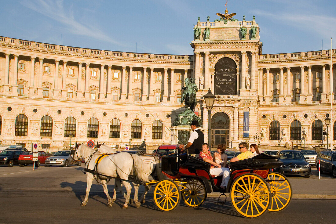 Fiaker passsing Neue Hofburg, Vienna, Austria