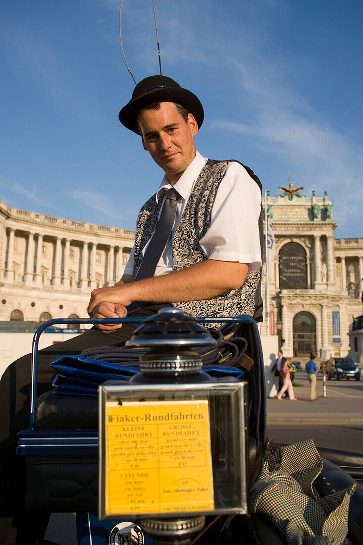 Fiaker coachman looking at camera, in front of Neue Hofburg, Vienna, Austria