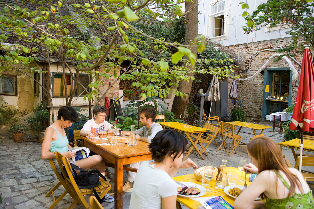 People sitting in open-air area of Stomach, Alsergrund, Vienna, Austria