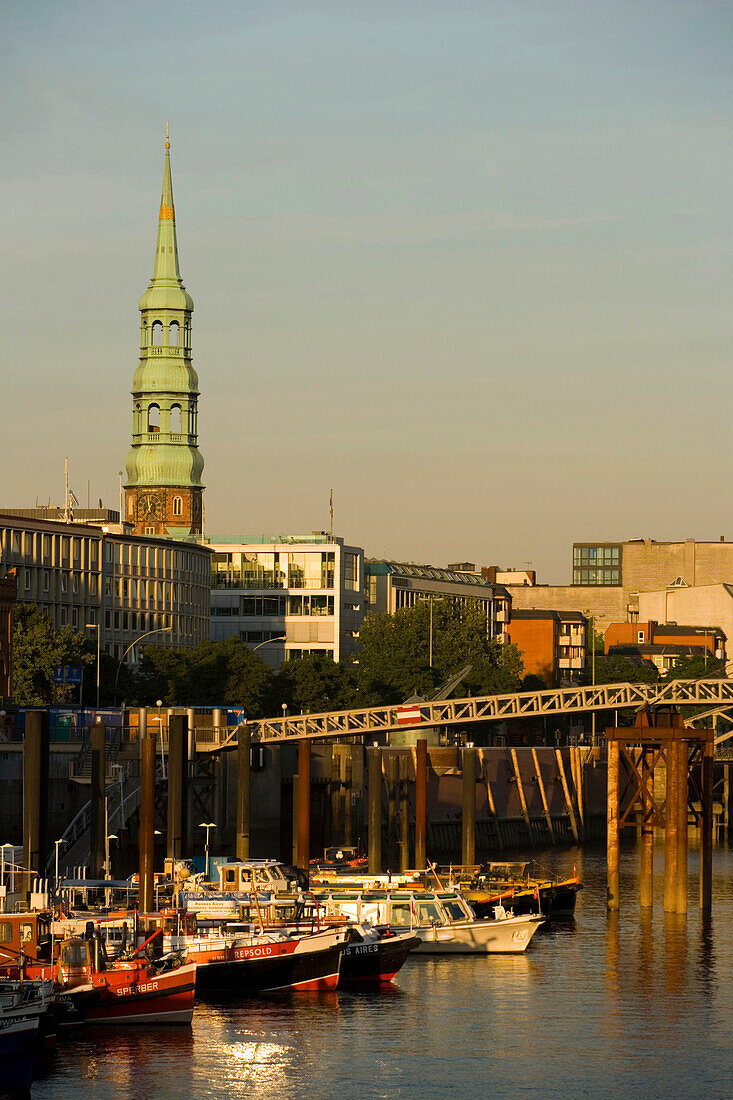 View at inner harbour with boats and steeple of church St. Katharinen, Hamburg, Germany