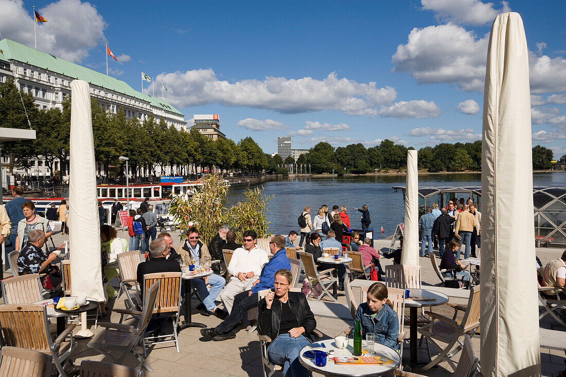People sitting in the open-air area of the restaurant Alsterpavillon, Hamburg, Germany