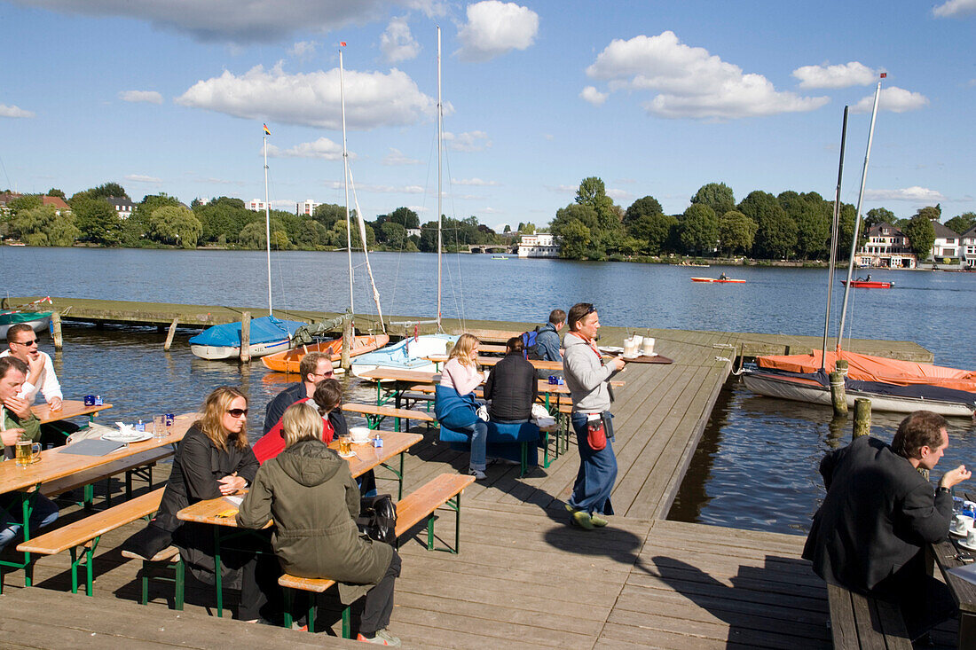 People sitting at Alster Cliff, People sitting in open-air area of Alster Cliff at lake Alster, Hamburg, Germany