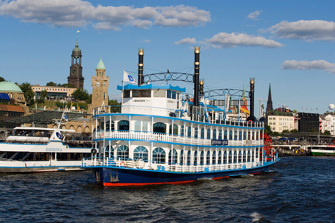 A paddlesteamer leaving the harbour, the steeple of St. Michaelis church in the background, Hamburg, Germany