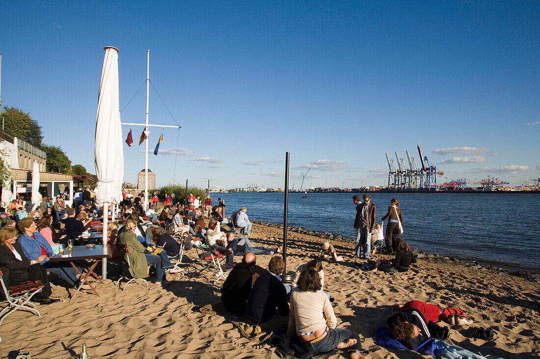 People relaxing at beach, People sitting at kiosk Strandperle at Elbe beach, Oevelgönne, Hamburg, Germany