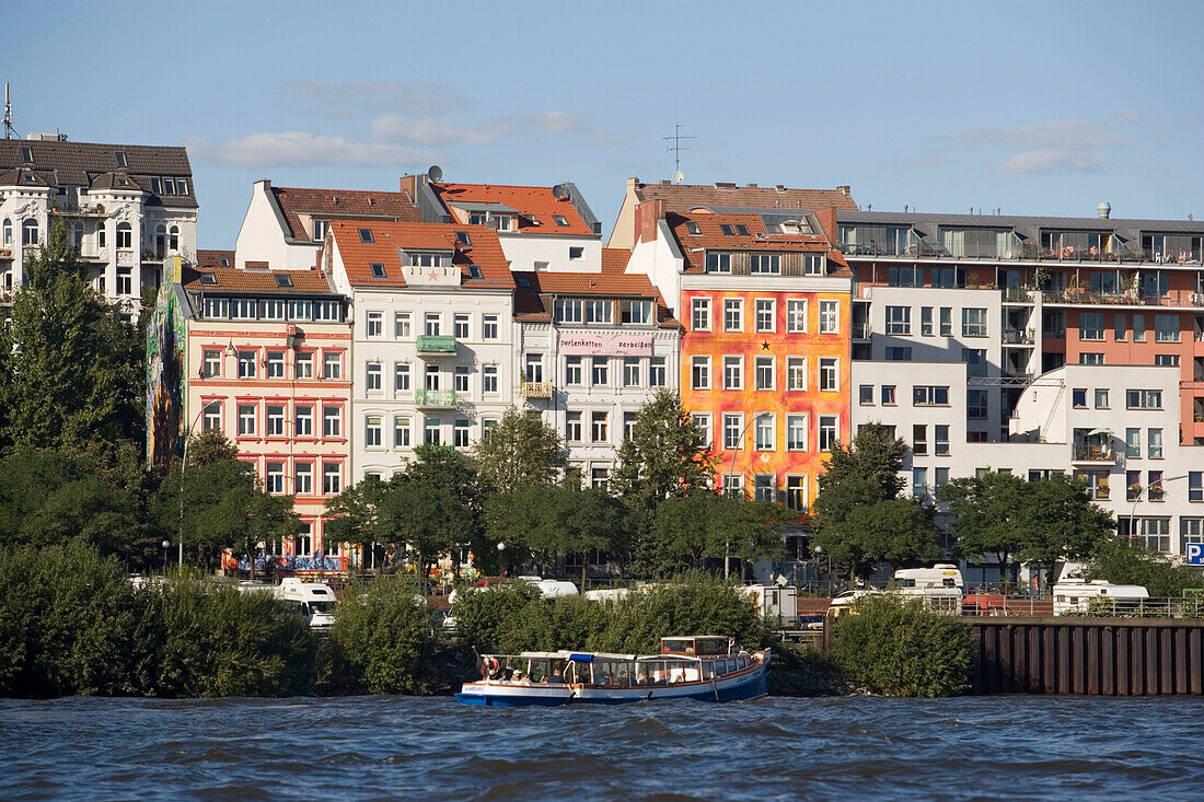 View over Elbe to buildings at Hafenstraße, View over the Elbe with barge to buildings at Hafenstaße, Hamburg, Germany