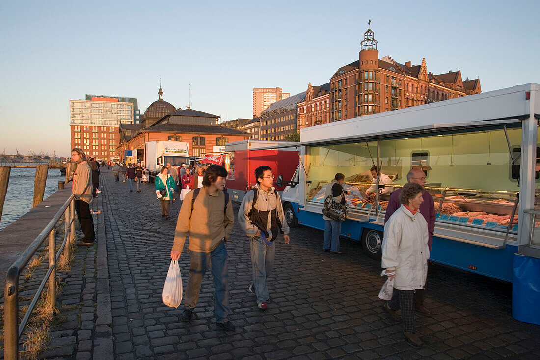 People walking over the fish market early in the morning, St. Pauli, Hamburg, Germany