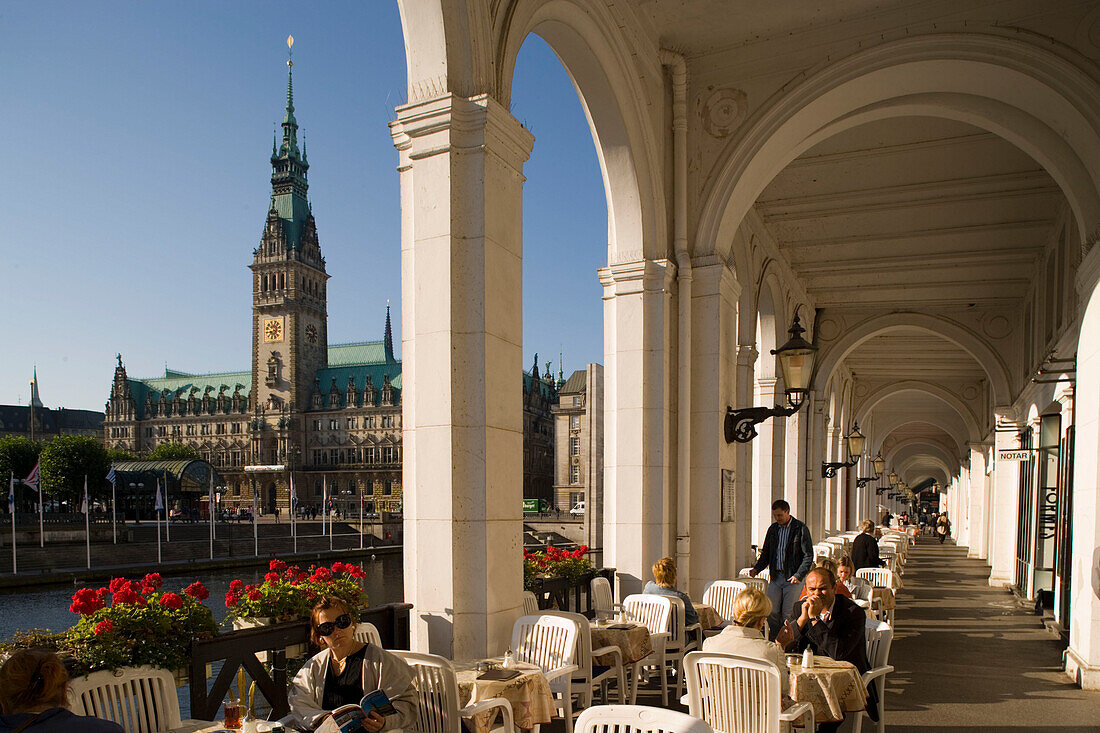 People sitting in cafe at Alsterarcades, view to town hall, Hamburg, Germany