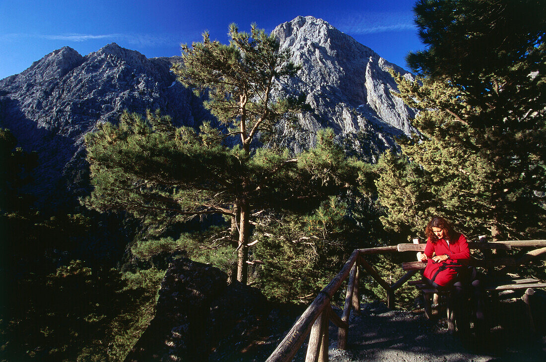 Woman sitting on bench, Samaria Gorge, Crete, Greece