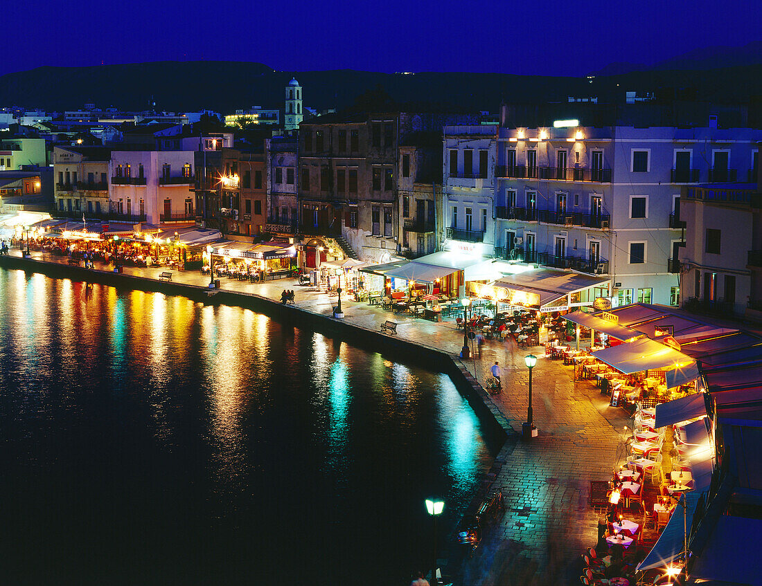 Illuminated Venetian Harbour at night with restaurants, Chania, Crete, Greece