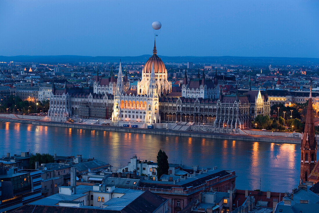 View over the Danube river to the illuminated Parliament in the evening, Pest, Budapest, Hungary