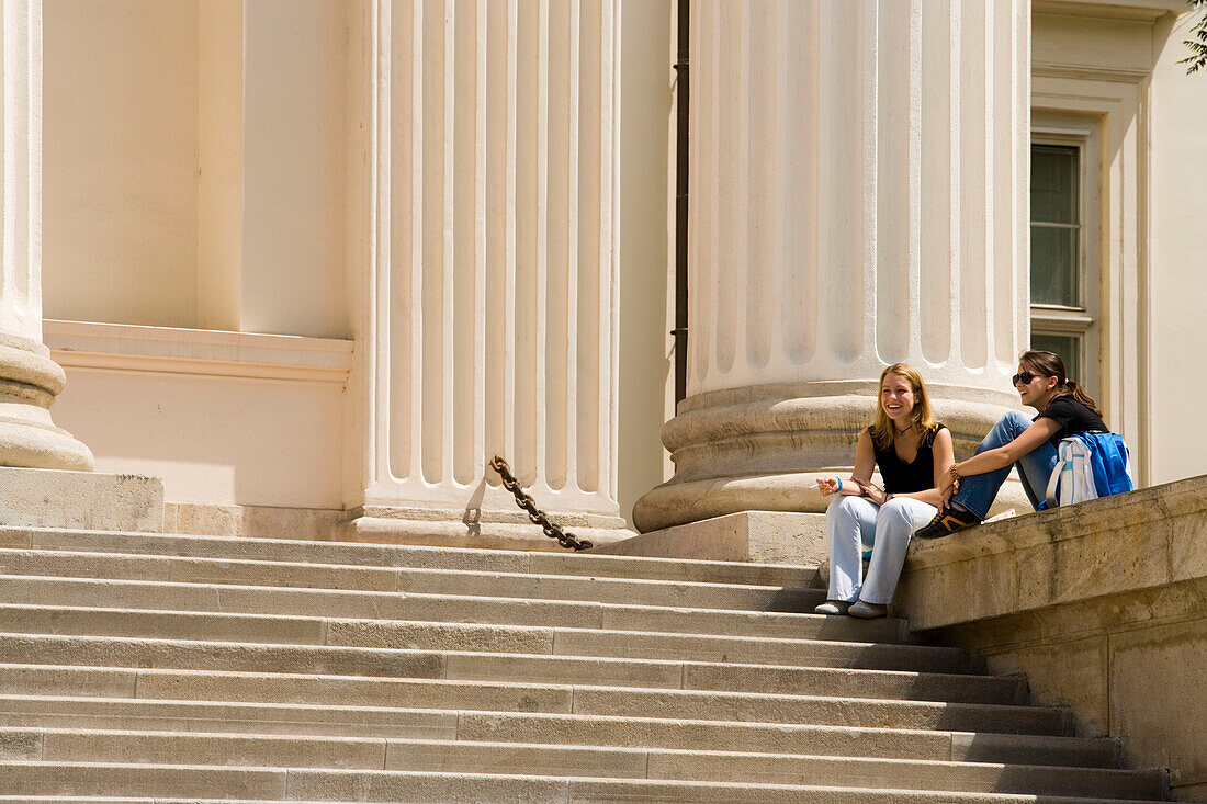 Woman on staircase of Hungarian National Museum, Two young women sitting on staircase of the Hungarian National Museum, Pest, Budapest, Hungary