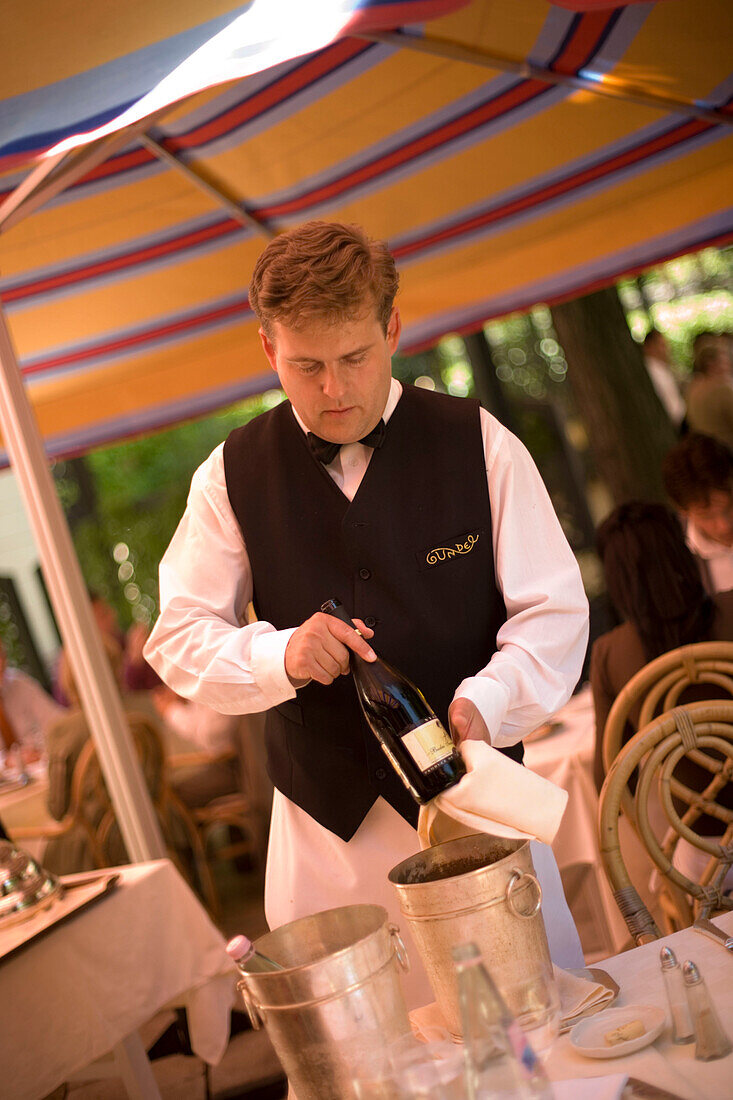Waiter presenting the wine, Waiter presenting the wine in the open-air area of the restaurant Gundel, Pest, Budapest, Hungary