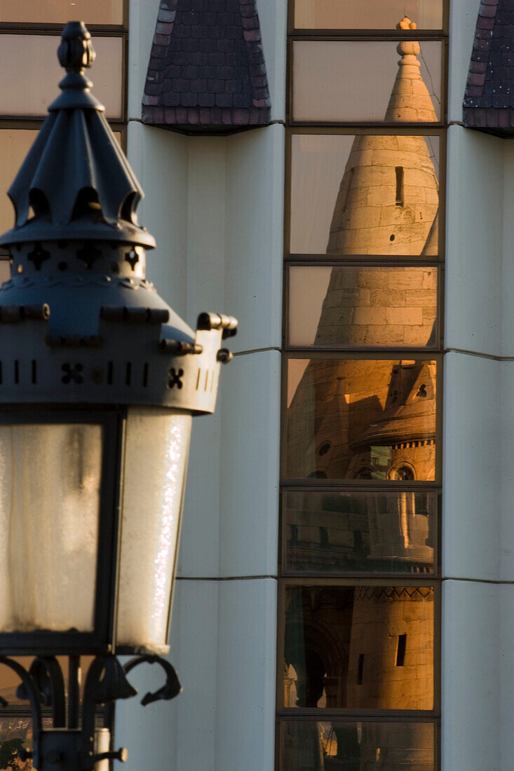 Reflection of the Fisherman's Bastion in the Hilton Hotel facade at Castle Hill, Buda, Budapest, Hungary