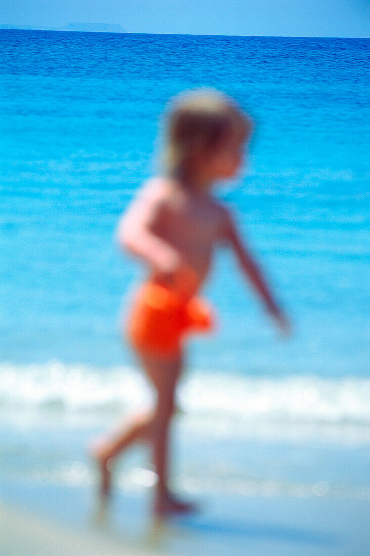 Little girl running on the beach