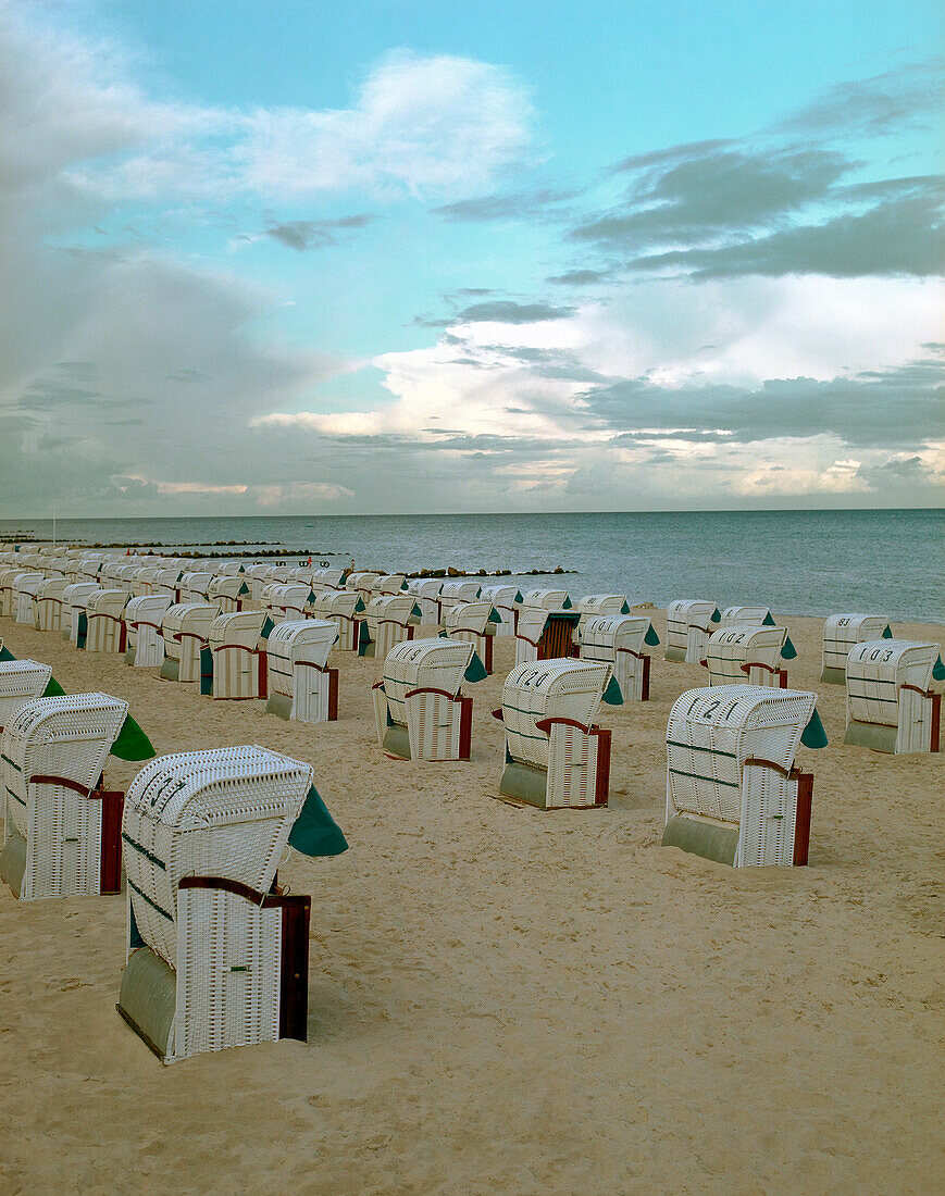 Hooded beach chairs on sandy beach, Timmendorfer Strand, Schleswig Holstein, Germany