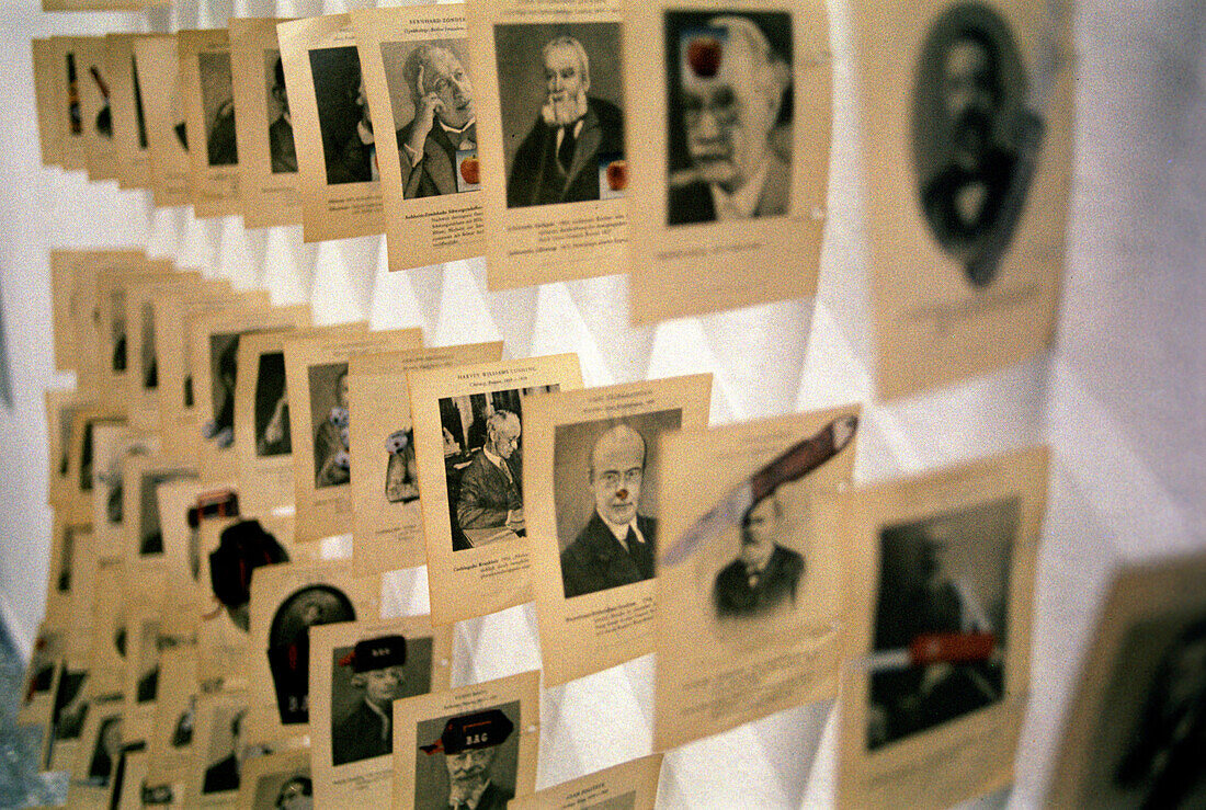 Rows of yellowed pages with human representation on a wall, Academy of Fine Arts, Munich, Bavaria, Germany