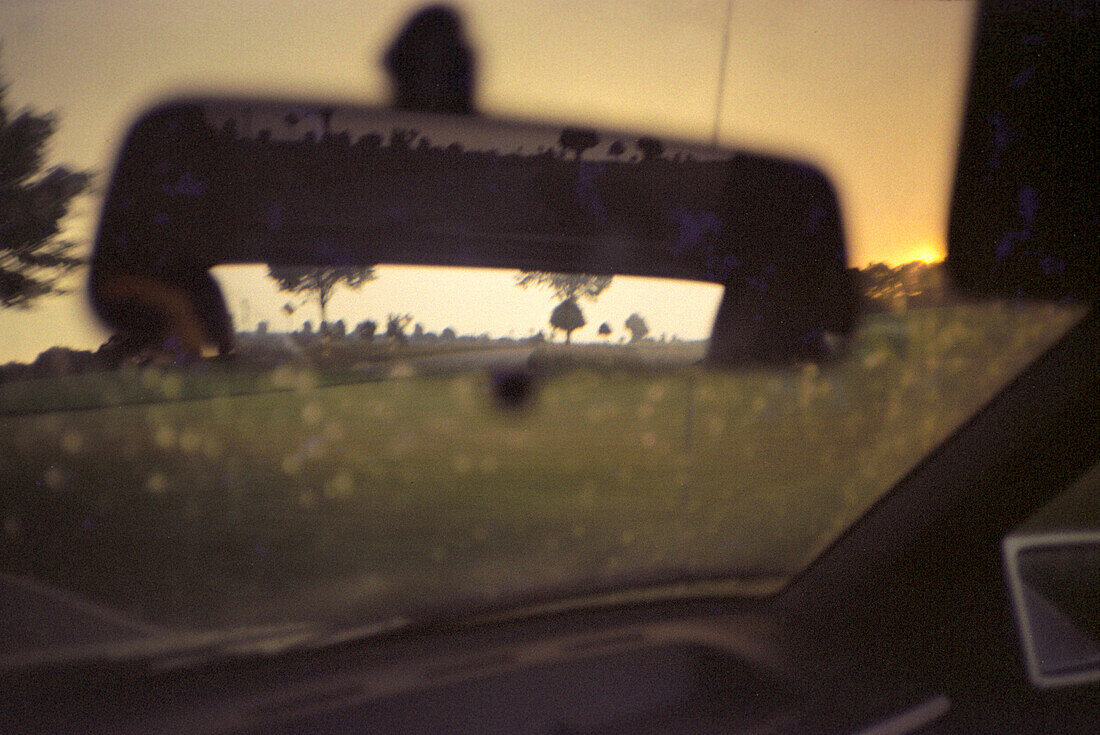 View out of the windscreen of a car at sunset, North Rhine-Westphalia, Germany