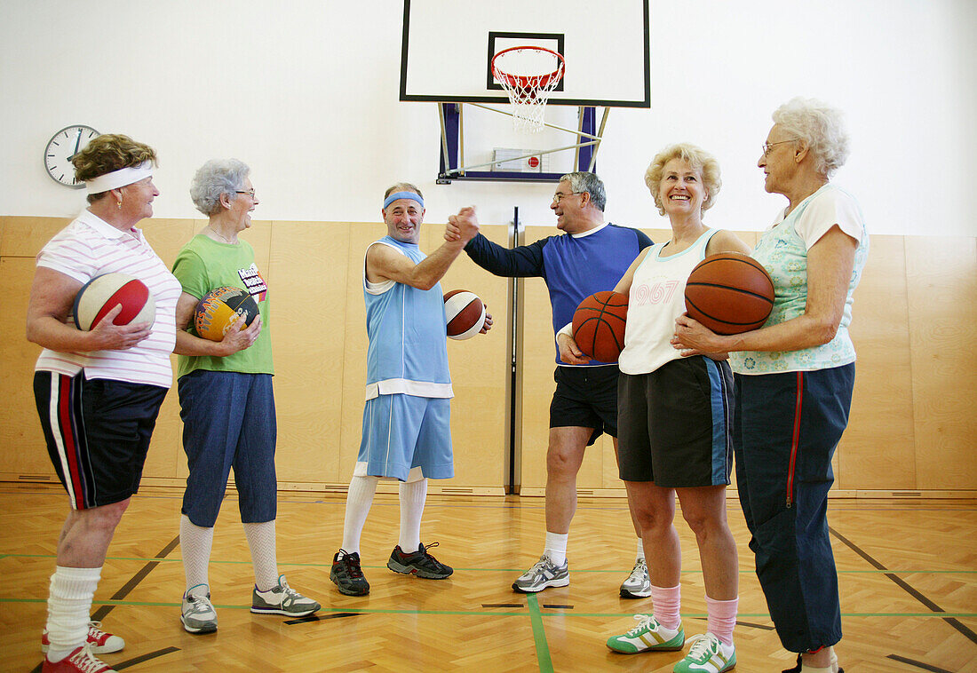 Mature People playing basketball