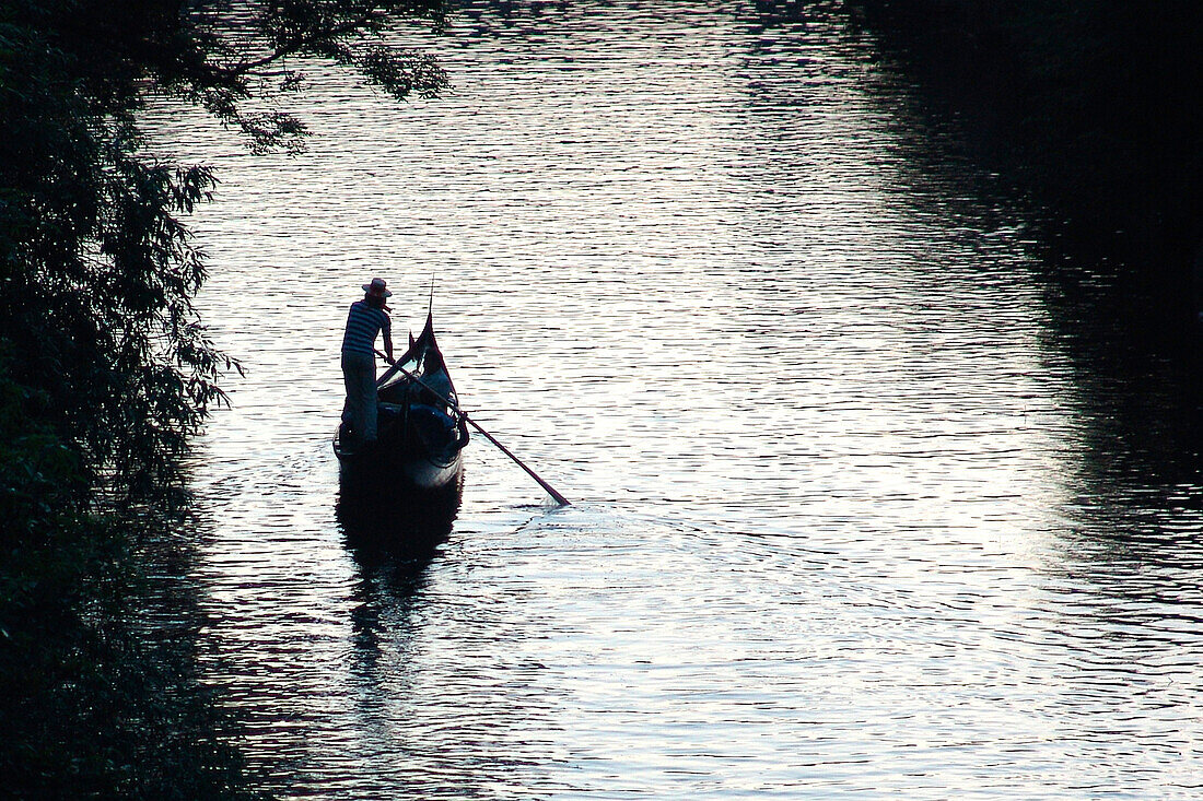 Lonely gondolier rowing on Elster river, Leipzig, Saxony, Germany
