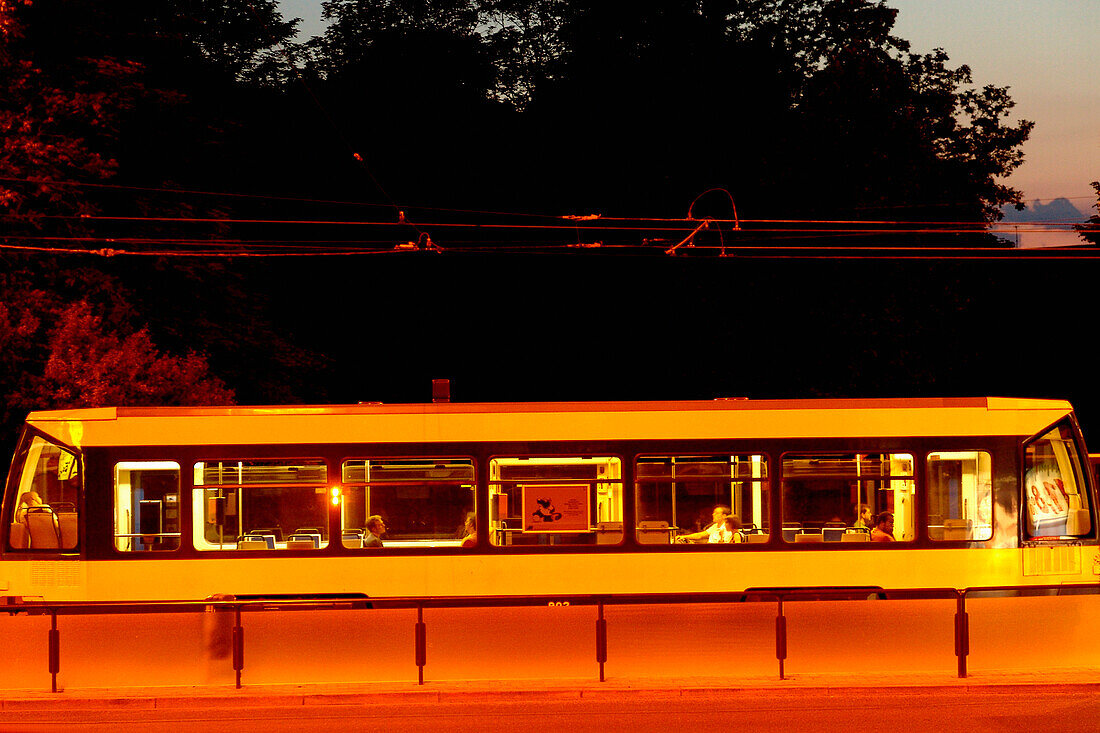Tramway with people inside at night, Leipzig, Saxony, Germany