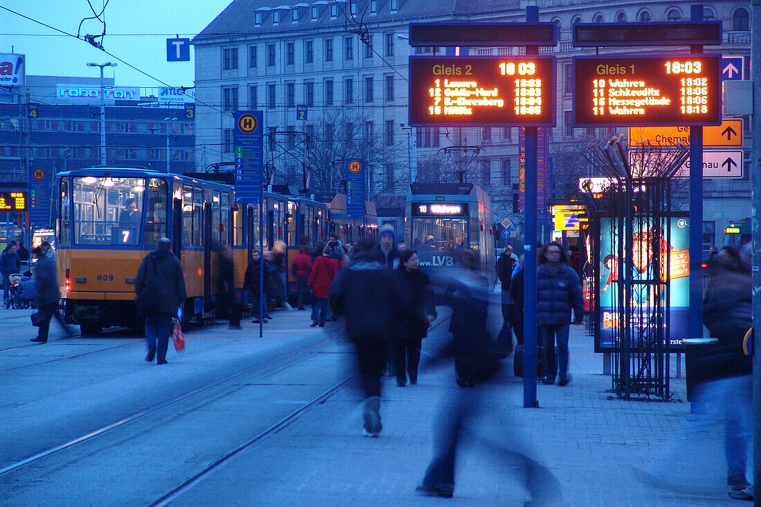 People at tram stop in front of Leipzig central station in the evening, Leipzig, Saxony, Germany, Europe