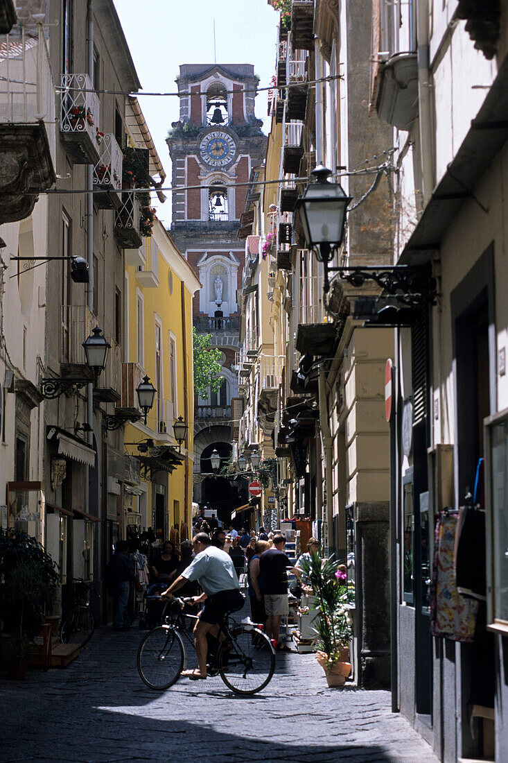 Bicyclist crossing alley in Sorrento, Campania, Italy