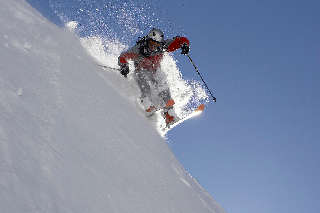 Skier jumping on powder snow, Bavaria, Germany