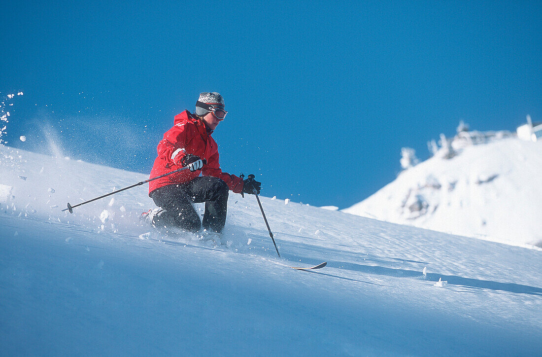 Woman telemark skiing on mountain side, side view, Zugspitze, Garmisch-Partenkirchen, Germany