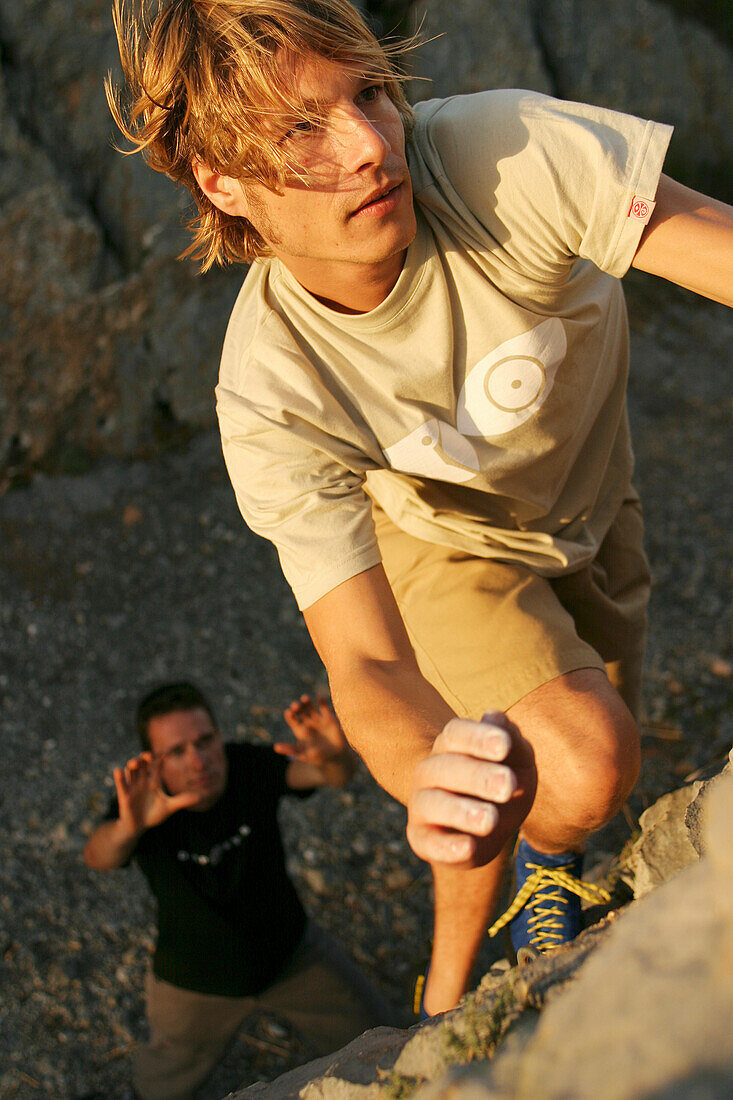 Young man rockclimber bouldering