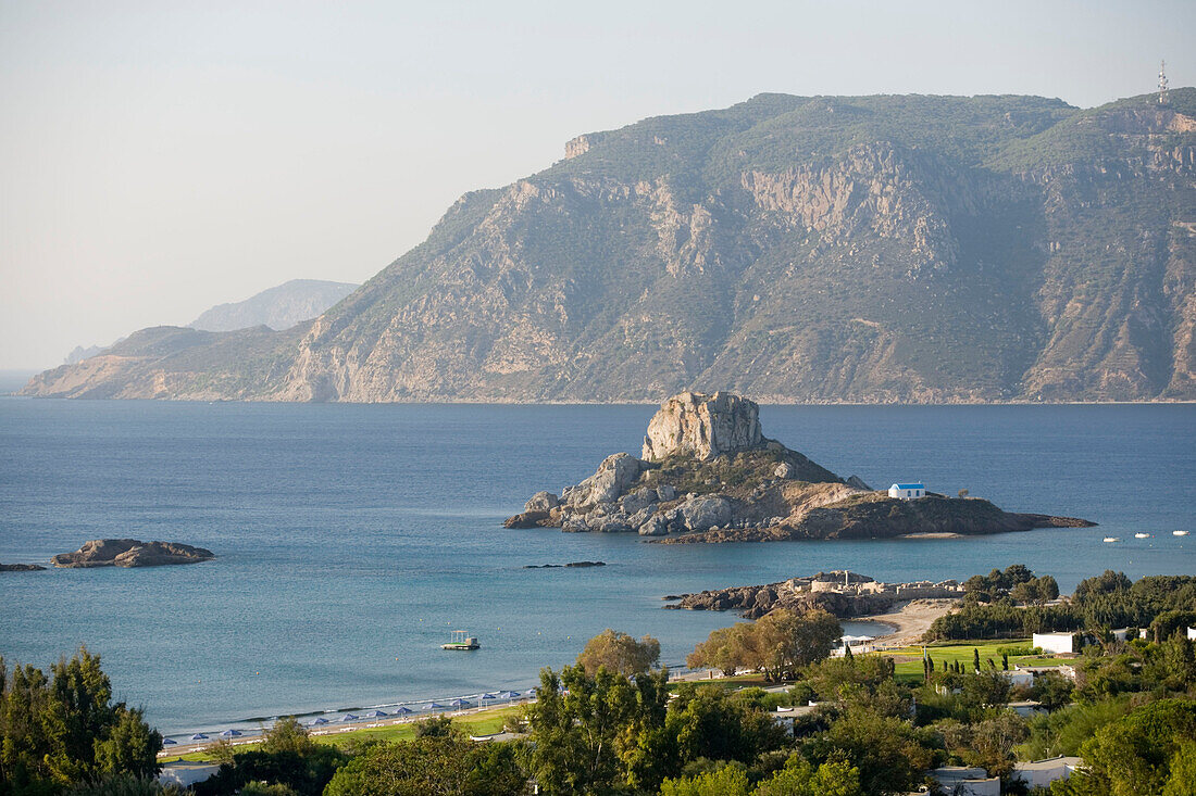 View over basilica Agios Stefanos at Kefalos beach to Kastri Island with St. Nicholas, Kos, Greece