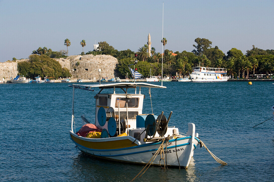 View over a fishing boat to Neratzia Castle, a former fortress of the Knights of St. John of Jerusalem, at Mandraki harbour, Kos-Town, Kos, Greece