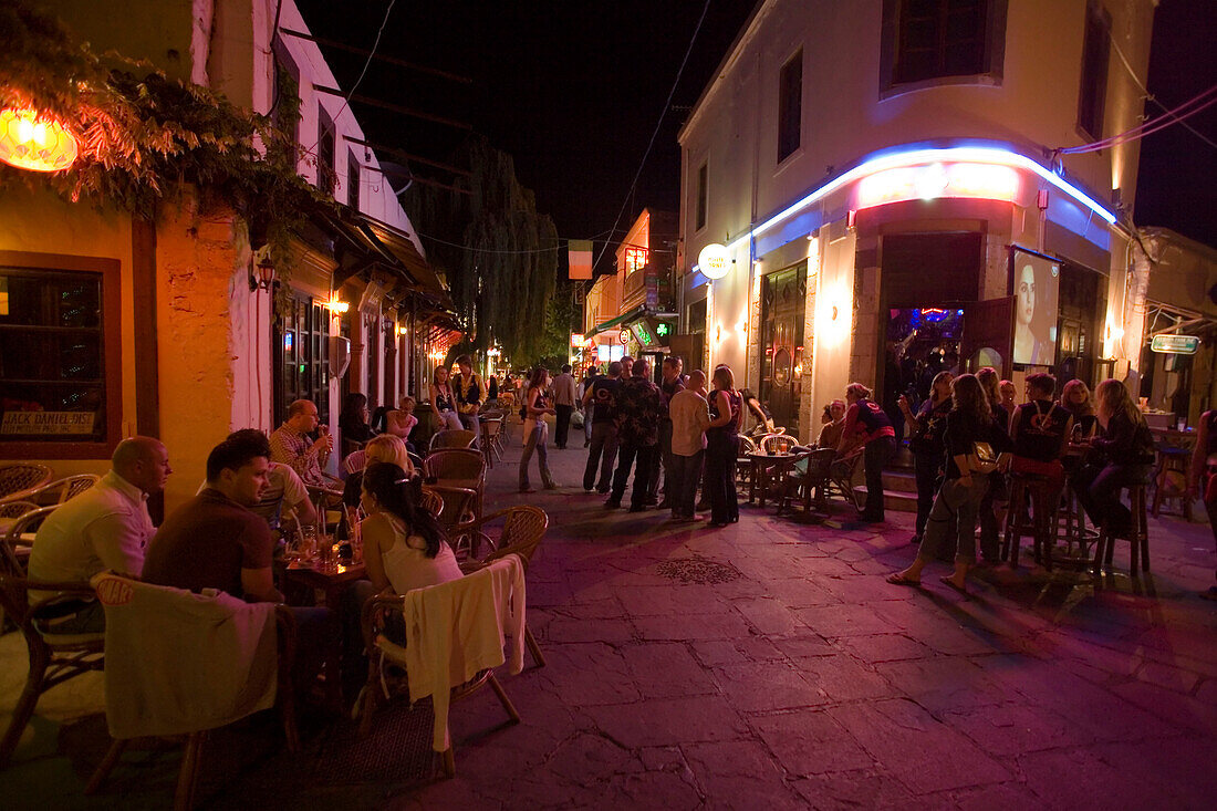 View inside a busy bar street with a lof of cafes and bars at night, Kos-Town, Kos, Greece