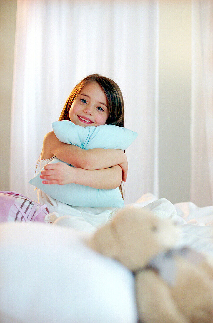 Girl hugging a pillow