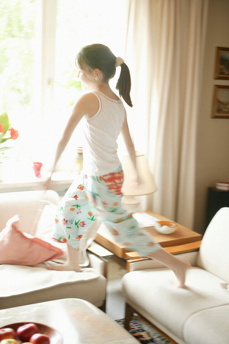 Girl running on sofa