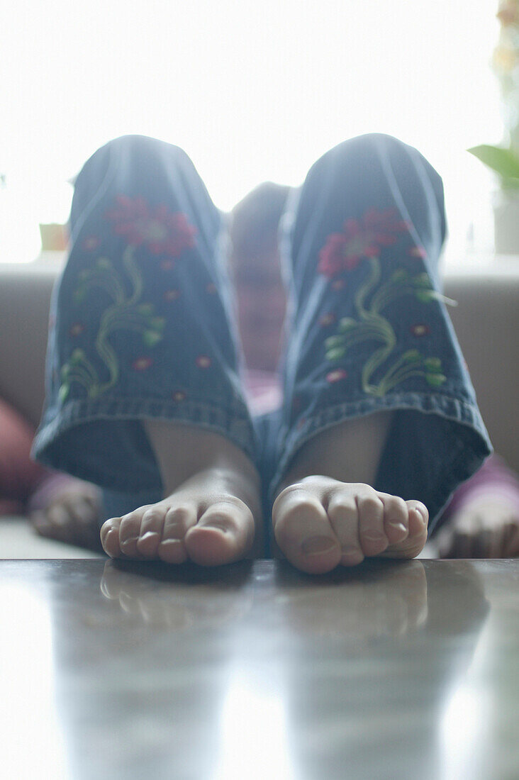 Girl with feet on table